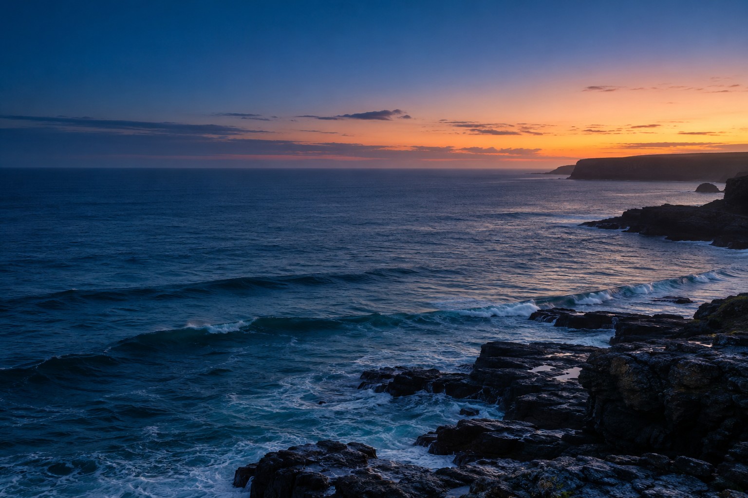 A quiet coastline in the soft light before sunrise